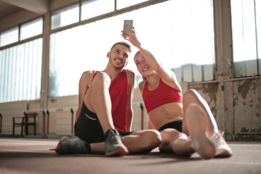 Woman in Red Sports Bra and Black Shorts Doing Selfie